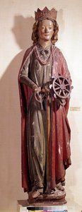 Representación de Santa Catalina de Alejandría, sosteniendo el instrumento de rueda de su tormento. Estatua de madera policromada
