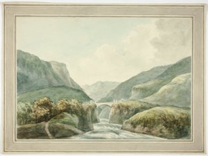 Pueblo de montaña por el puente que salva los rápidos
