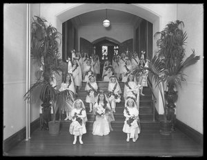 Niñas en el Asilo de Huérfanos Católicos Romanos, Kingsbridge, Bronx, regresando de la capilla con vestidos blancos con coronas y guirnaldas, 20 de octubre de 1914 de William Davis Hassler