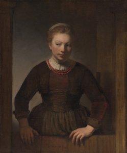 Mujer joven ante una puerta medio abierta de Workshop of Rembrandt van Rijn