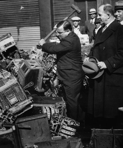 Fiorello La Guardia (1882-1947) destruyendo máquinas tragamonedas confiscadas de American Photographer