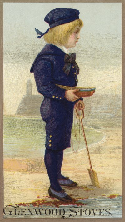 Niño de pie en la orilla del mar con un barco en las manos de American School