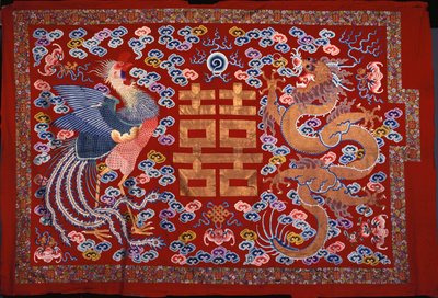 Un colgante chino de lana roja con un carácter central en hilo dorado flanqueado por un fénix y un dragón, siglo XIX de Chinese School