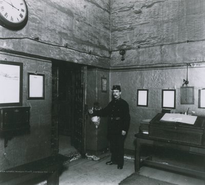 Un guardia de prisión junto a una puerta en el vestíbulo de entrada de English Photographer
