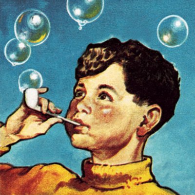 Niño soplando burbujas con una pipa de English School