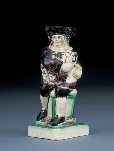 Jarra de Dick Whittington, moldeada levantándose de una silla de respaldo alto, sosteniendo a su gato, salpicada en ropa marrón, verde y negra, un escudo moldeado a su lado de English School