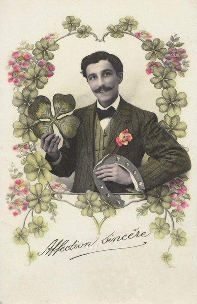 Un hombre con un trébol de cuatro hojas y una herradura. de French School