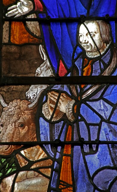 Ventana que representa a un donante en la Natividad de French School
