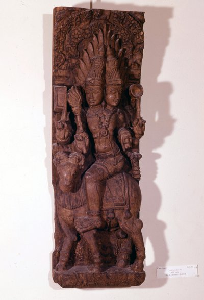Agni, dios del fuego, representado con dos cabezas (bicefalo) sobre un carnero, según la mitología hindú. Escultura de madera del siglo XVII. París, Museo Guimet de Indian School