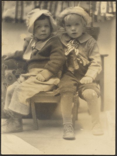 [Dos niños comparten silla] de Louis Fleckenstein