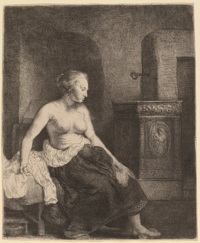 Mujer sentada medio vestida junto a una estufa de Rembrandt van Rijn