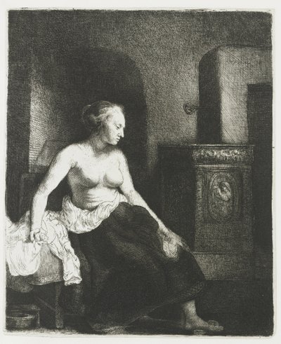 Mujer sentada a medio vestir junto a una estufa de Rembrandt van Rijn