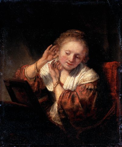 Joven mujer probándose aretes, 1657 de Rembrandt van Rijn