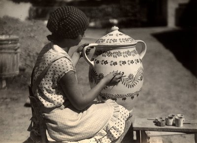 Una dama húngara retratada mientras pinta un ánfora con motivos florales; al lado, sobre un pequeño banco, los pinceles y los vasos con los colores. de Rudolf Balogh
