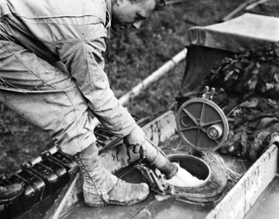 Segunda Guerra Mundial (1939-1945): Normandía (Francia) verano 1944: En una estación de almacenamiento de gas, un soldado de una compañía de transporte de EE.UU. reposta el tanque de un camión cisterna GMC de Unbekannt