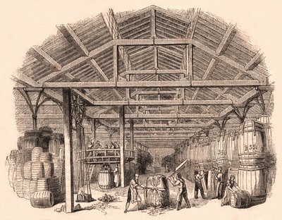 Interior de una fábrica de tabaco: trabajadores cortando una bola de tabaco y otros involucrados en la fabricación y manejo de barriles de Unknown