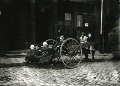 Grupo de niños en un carro, con una niña y una mujer de pie detrás, c.1910-21 de William Davis Hassler