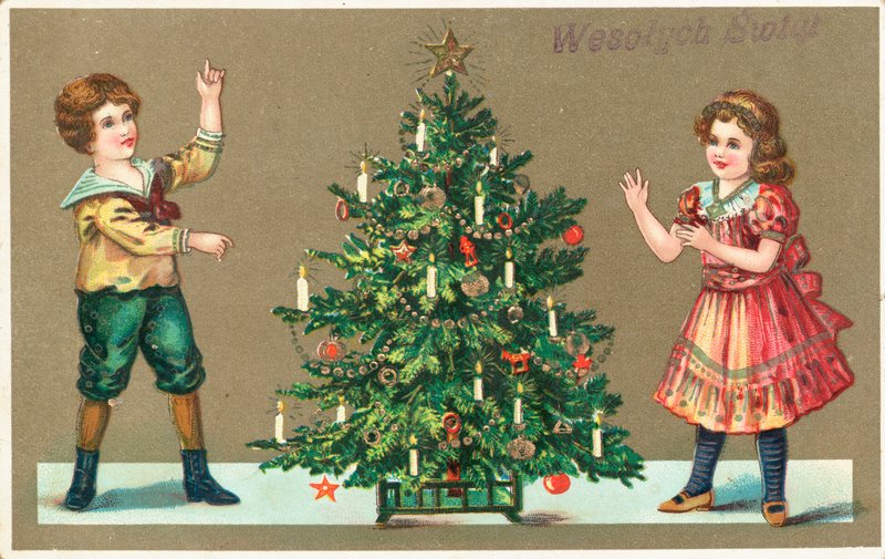 Niña y niño con árbol de Navidad de German School