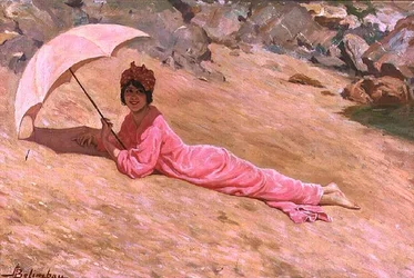 Niña acostada en la playa con una sombrilla rosa