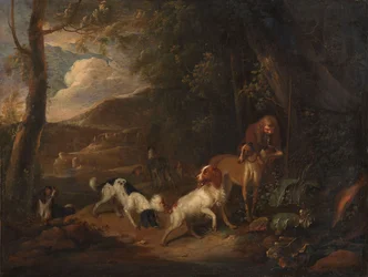 Cazador con perros al borde de un bosque