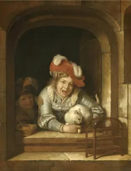 Dos niños juegan con un gato que tiene un pájaro en las fauces