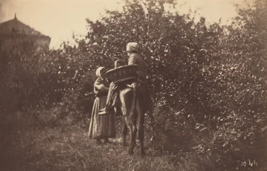 Dos mujeres con un burro, finales de la década de 1870 (foto)