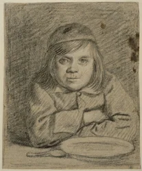 Niño con los brazos cruzados en una mesa