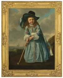 Retrato de un niño jugando al golf en la orilla