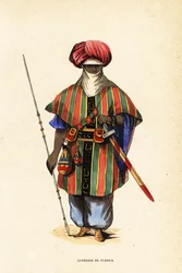 Guerrero tuareg noble de Agadez, Níger, con tagelmust (turbante y velo), taktkat (camisa) y akarbey (pantalones)