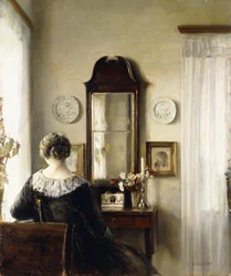 Interior con una mujer sentada junto a una ventana