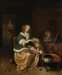 Interior con una madre peinando el cabello de su hijo, conocido como 