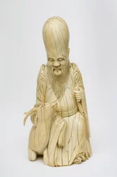 Figura de marfil tallada de Shou Xing sentado con un ciervo, c.1580-1644