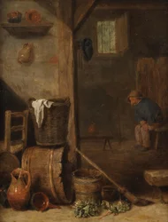 Interior de una cocina con una figura sentada en la habitación contigua