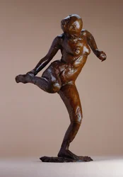 Desnudo mirando la planta de su pie derecho