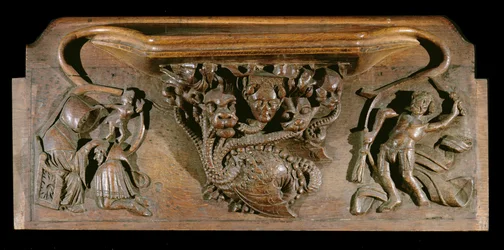 Una misericordia que representa una hidra elaboradamente tallada, simbólica de los siete pecados capitales, incorporando una cabeza humana realista, Capilla del New College, Oxford, finales del siglo XIV (madera)