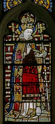 Ventana Ew que representa a Santo Tomás Becket con joyas de vidrio incrustado