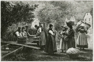 Una lavandería en Metzeral, mujeres con trajes tradicionales del valle se reúnen en la fuente del pueblo. Grabado de E. Ronjat, para ilustrar la historia “Atravers l
