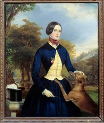 Retrato de una mujer en una amazona con su perro