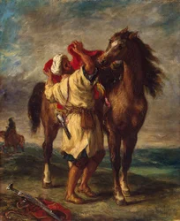 Árabe ensillando su caballo