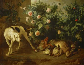 Perro guardando caza junto a un arbusto de rosas