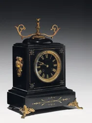 Un reloj de chimenea de piedra negra, con decoración incisa, con patas, remates y accesorios en latón dorado, por Jausions de Pau, Francia, c.1876-78
