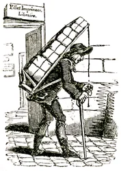 Comisionado (mensajero) en el siglo XIX saliendo del librero Pillet en París, llevando una carga de libros a la espalda.
