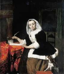 Una dama elegante escribiendo en su escritorio, con un perro a su lado