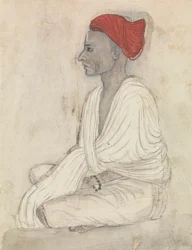 Hombre con turbante rojo sentado con las piernas cruzadas