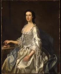 Mary, esposa de Henry, 7mo Lord Arundell de Wardour, en un vestido de satén gris, sosteniendo rosas junto a una mesa