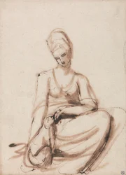 Mujer sentada alimentando a un animal