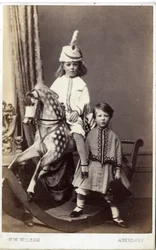 Niña con sombrero en caballo de juguete con otra niña de pie, 1860s