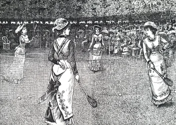 Damas jugando al tenis en el césped