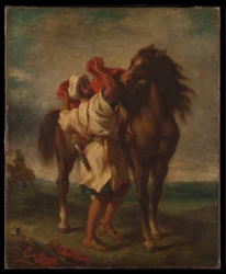 Árabe ensillando su caballo