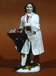 Estatuilla de Meissen de un vendedor de espectáculos (porcelana)